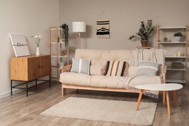 Konforlu bej kanepeli bir oturma odası.