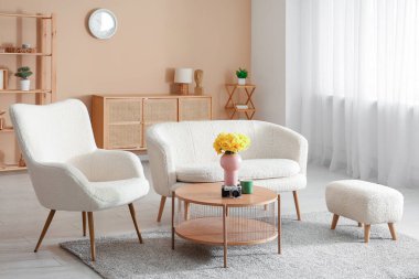 Oturma odası, kanepe, koltuk ve nergis çiçekleri.