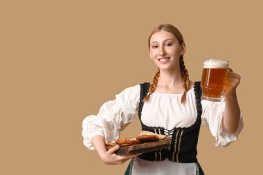 Güzel mutlu Ekim Festivali garsonu, birası ve bej arka planda geleneksel yemekleri var.