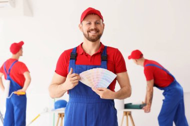 Odada boya rengi paletleri olan erkek dekoratör