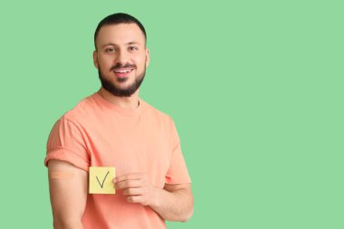 Yeşil arka planda uygulamalı tıbbi yaması olan genç bir adam. Dokunulmazlık kavramı