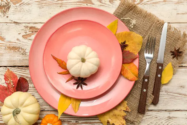 Taze balkabaklarıyla, yıldız anasonlarıyla, çingene çiçekleriyle ve beyaz ahşap arka planda sonbahar yapraklarıyla güzel bir masa.