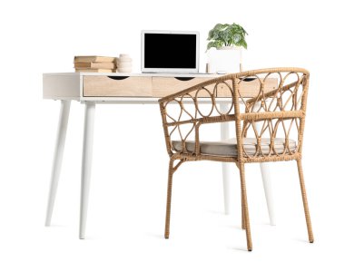 Modern dizüstü bilgisayarı ve beyaz arka planda izole edilmiş ev bitkisi ile şık çalışma alanı