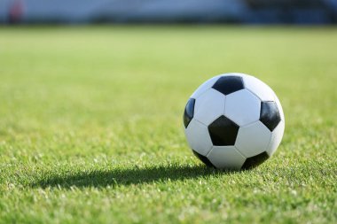 Yeşil çimlerde futbol topu, yakın plan.