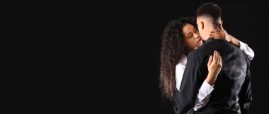 Siyah arka planda sarılan genç bir çift. Yin Yang konsepti