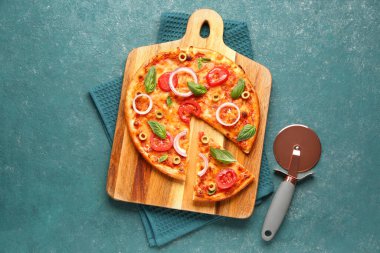 Lezzetli pizza, bıçak ve havlu ve grunge mavi arka planda.