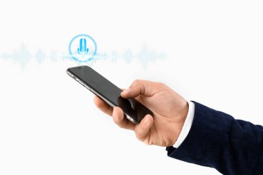 Young businessman using mobile phone on light background, closeup