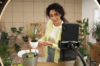 Evinde bitki kayıt videosu olan Afro-Amerikalı bir blog yazarı