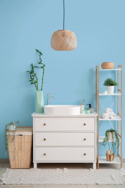 Interior of bathroom with sink, drawers and shelving unit