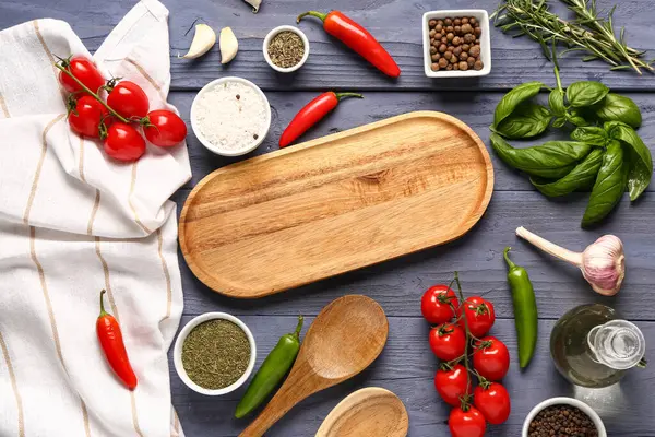 Mutfak tahtası, baharat ve sebzeli kompozisyon koyu ahşap arka planda