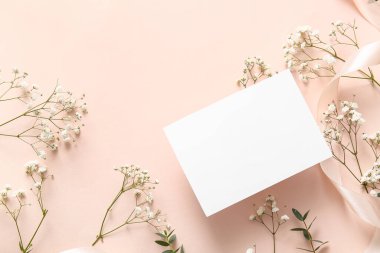 Boş kâğıt kaplamalı kompozisyon ve pembe arka planda güzel çigila çiçekleri