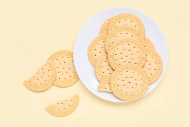 Sarı zemin üzerinde tatlı kurabiyeler olan tabak.