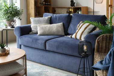 Interior of stylish living room with glowing lamps and sofa