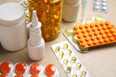 Beyaz tahta arka planda farklı haplar ve ilaç şişeleri.