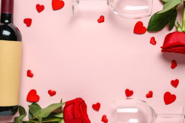 Frame made of wine bottle, glasses and rose flowers on pink background. Valentine's Day celebration