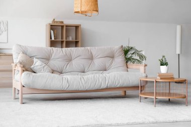 Rahat kanepesi, çiçekleri ve kahve masası olan güzel bir oturma odası.