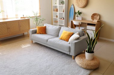 Interior of stylish modern living room with surfboard