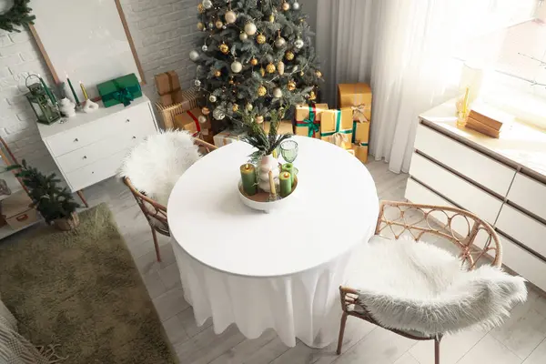 Masası, çekmecesi ve Noel ağacı olan yemek odasının içi.