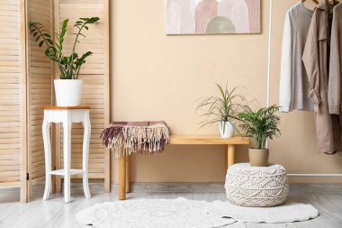 Bankta, perdede ve odada bej duvarın yanındaki evlerde.