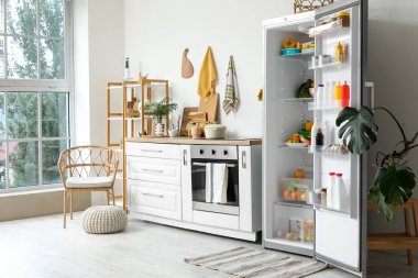 Açık buzdolabı, tezgah ve raf üniteli açık mutfak.