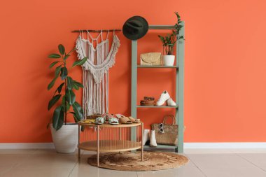 Koridorun içinde masa, raf ünitesi ve kadın ayakkabıları var.