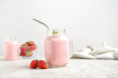 Masada bir kavanoz lezzetli çilekli smoothie var.