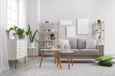 Grey sofa with cushions in interior of modern living room
