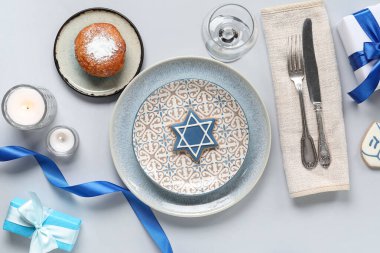 Gri arkaplanda Hanuka süslemeleri olan şenlikli masa ayarları