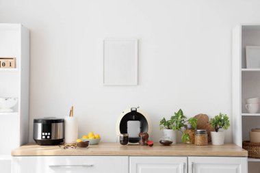 Modern kahve makinesi, kapsüllü ve fasulyeli mutfak tezgahında.