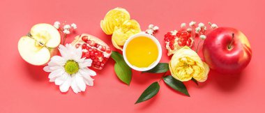 Kırmızı arka planda bal, meyve ve çiçeklerle beste. Rosh hashanah (Yahudi Yeni Yılı) kutlaması