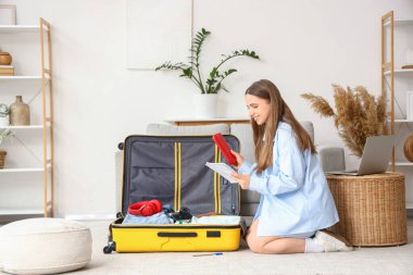 Evinde bavul hazırlayan listedeki kadın turist.