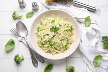 Brokoli ve fesleğen yapraklı bir kase lezzetli farfalle makarna.