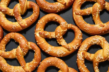 Siyah arkaplanda çok lezzetli tuzlu kraker var.