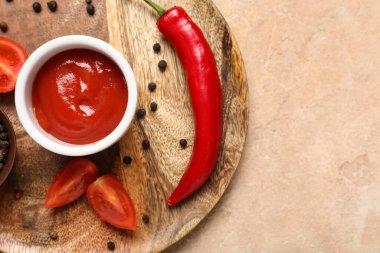 Ahşap tabak ve bir kase taze domates ezmesi, biber ve kırmızı biber.
