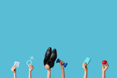 Erkeğin sembolü olan kadın elleri, mavi arka planda haplar, ayakkabılar ve kalp. Prostat Kanseri Farkındalığı Ayı