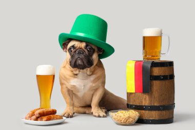 Üzerinde Almanya bayrağı, atıştırmalıklar, fıçı bira ve gri arka planda oturan tatlı Fransız bulldog 'u. Ekim Festivali Kutlaması