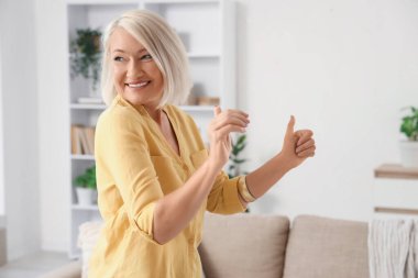 Evde dans eden olgun bir kadın.