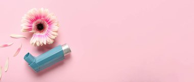 Pembe arka planda çiçek olan astım spreyi