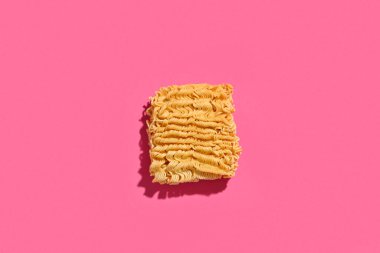 Pembe arka planda çiğ erişte.