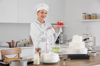 Mutfakta lezzetli pastası olan bir kadın pastacı.