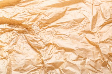 Arkaplan olarak buruşmuş bej kağıdın dokusu