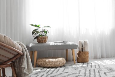 Çiçekli yumuşak bank ve odanın penceresinin yanında dergiler