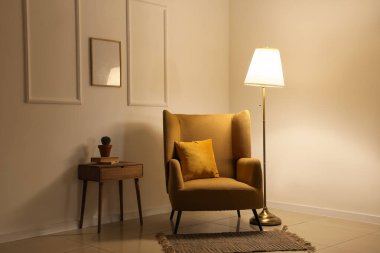 Akşamları koltuğu, masası ve parlayan lambası olan karanlık odanın içinde.