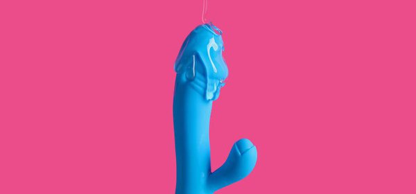 Vibrator covered with lubricant on bright pink background, closeup