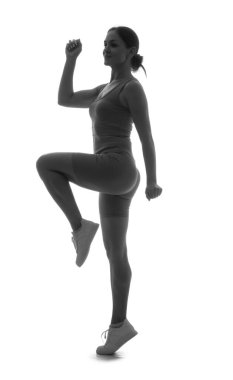 Beyaz arka planda spor yapan kadın silueti.