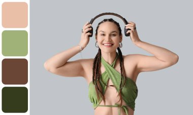 Gri arka planda Afrika örgüleri ve kulaklıkları olan şık genç bir kadın. Farklı renk desenleri