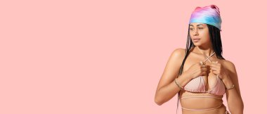 Pembe arka planda mayo giymiş havalı Afro-Amerikalı kadın. Mesaj için yeri var.