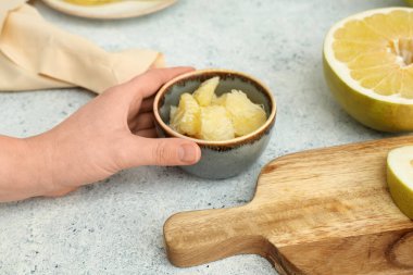 Beyaz arka planda bir kase taze aromalı kadın eli.