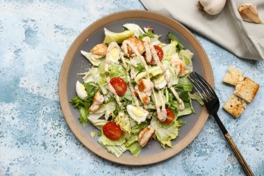 Mavi arka planda lezzetli tavuklu Sezar salatası.