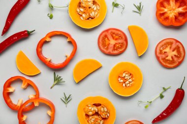 Gri arka planda taze sebzeler ve bitkilerle yakın plan kompozisyonu.